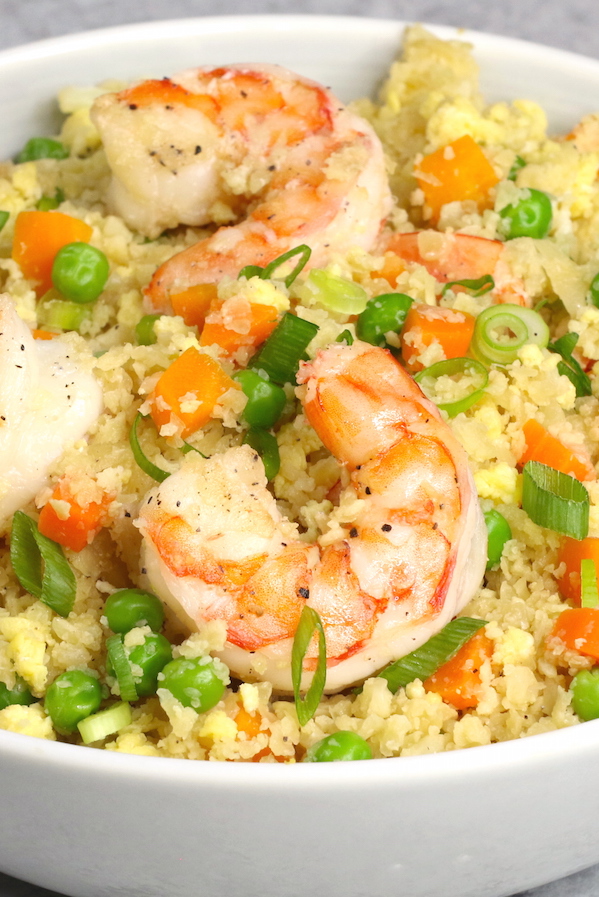 A serving of cauliflower fried rice with jumbo shrimp