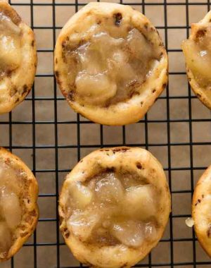 Apple Pie Cups with a cinnamon roll crust on a wire rack after baking