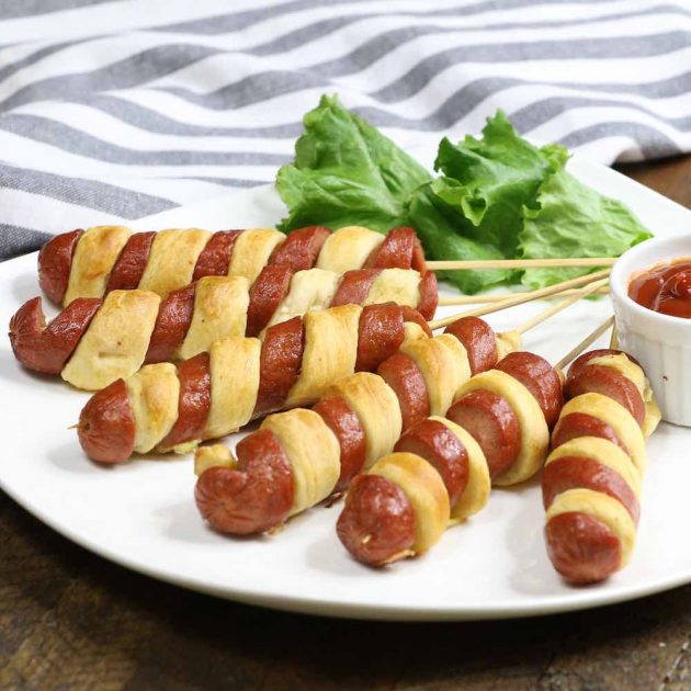 Crescent Dogs with a tornado dog spiral presentation served with ketchup as a dipping sauce for the perfect party appetizer 