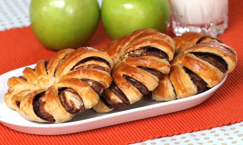 A serving of beautiful braided Nutella bread with a glass of cold milk