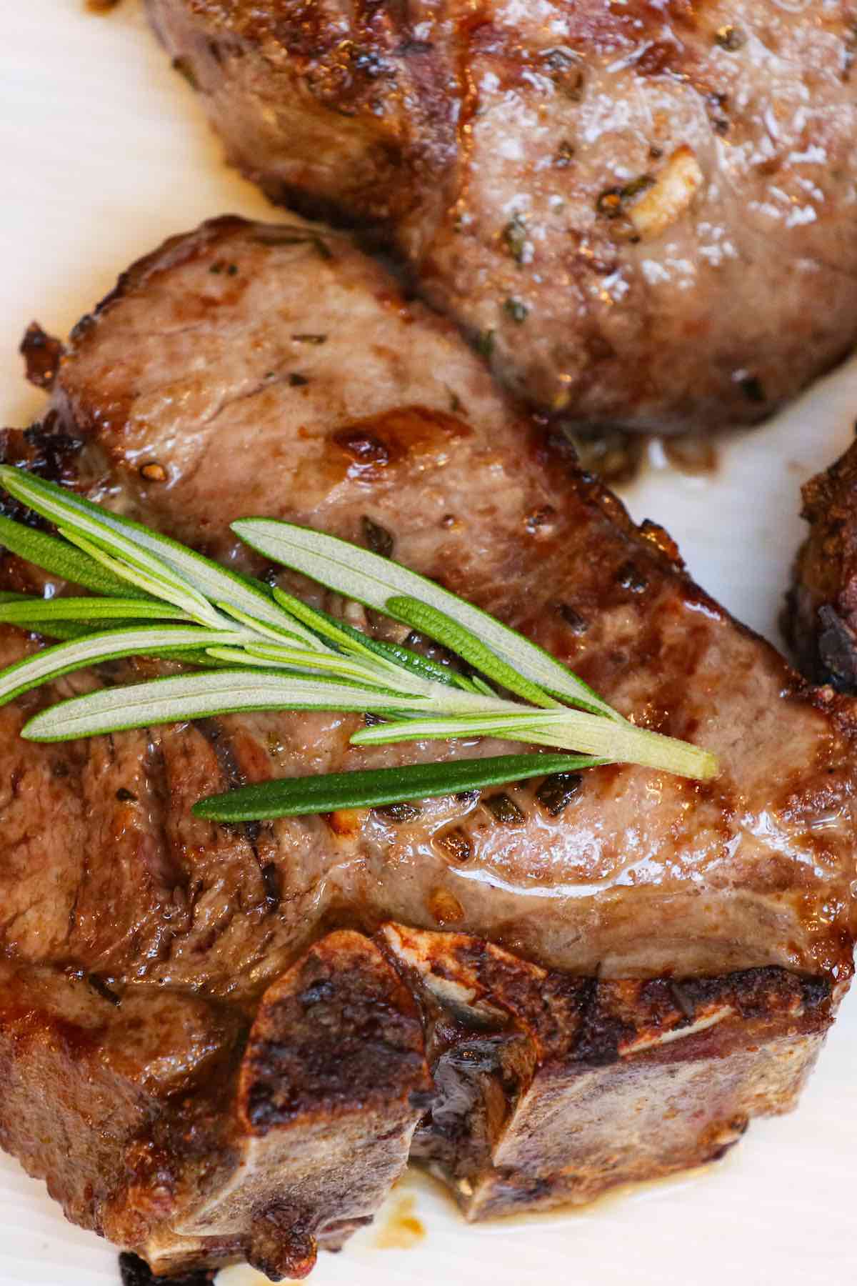 These Air Fryer Lamb Chops are juicy and flavorful with a crispy crust. This easy recipe is the fastest way to cook lamb chops, cutlets or a rack of lamb. They marinate briefly in garlic, rosemary and olive oil before cooking for just 10-12 minutes at 400°F! #AirFryerLambChops