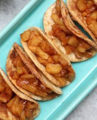 Super Easy Baked Apple Pie Tacos – delicious cinnamon sugary apple filling in a crispy and sweet taco, drizzled with caramel sauce, and then topped with whipped cream! The easiest dessert that comes together in no time. All you need is a few simple ingredients: Flour Tortillas, butter, cinnamon, sugar, apples, lemon, caramel sauce and whipped cream.