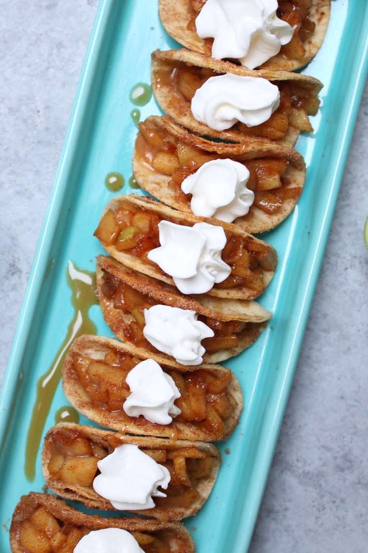 Super Easy Baked Apple Pie Tacos – delicious cinnamon sugary apple filling in a crispy and sweet taco, drizzled with caramel sauce, and then topped with whipped cream! The easiest dessert that comes together in no time. All you need is a few simple ingredients: Flour Tortillas, butter, cinnamon, sugar, apples, lemon, caramel sauce and whipped cream. It’s the perfect way to serve apple pie to a crowd! Quick and easy recipe. Great for party dessert and holiday brunch such as Easter, Mother’s Day or Father’s Day. Video recipe. | Tipbuzz.com