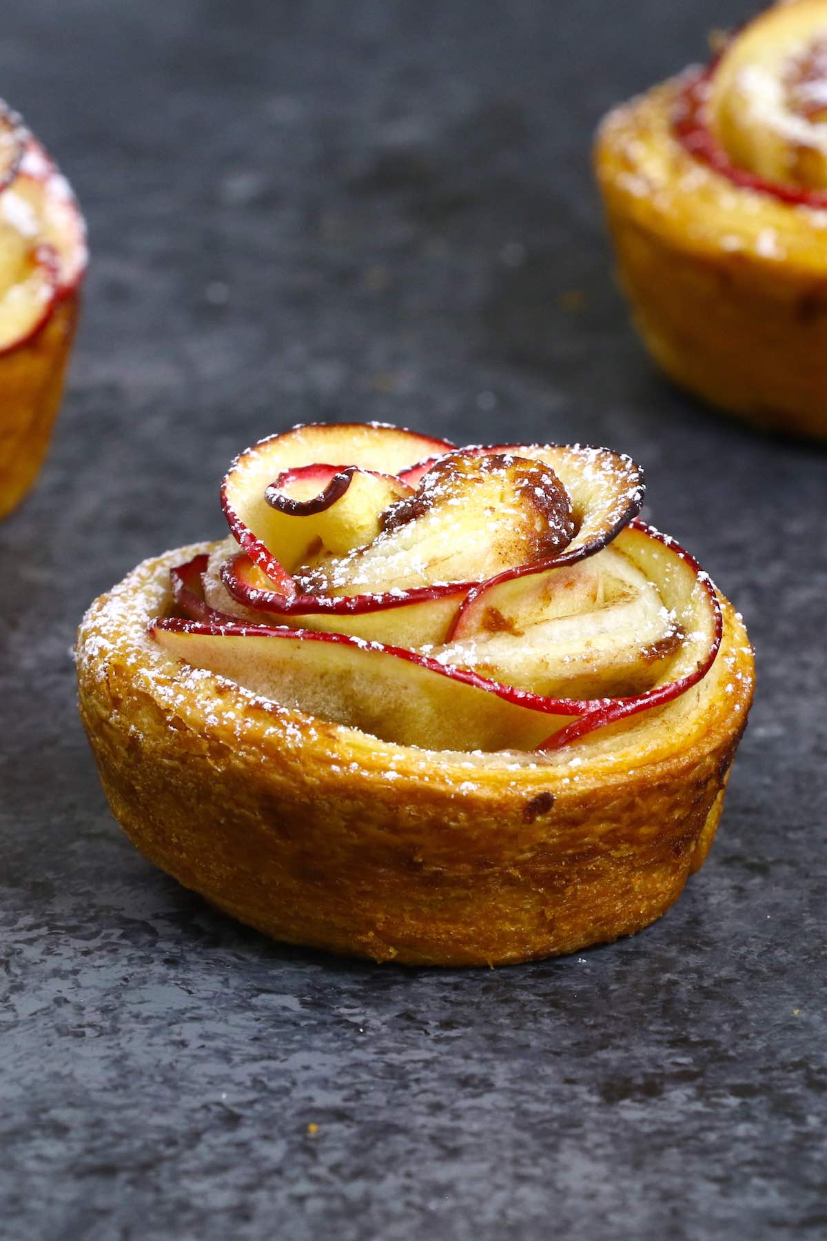 Closeup of an apple rose made with red delicious apples and cinnamon roll dough