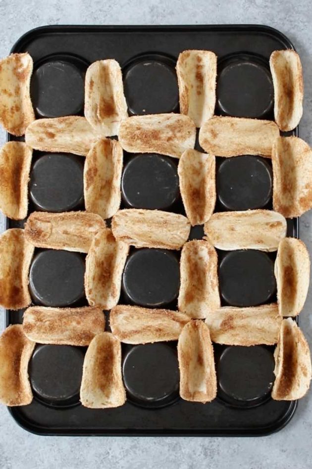 An upside down muffin pan holding baked mini tortillas when making dessert tacos