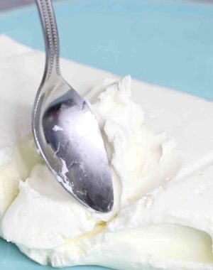 Checking whether cream cheese is softened using the back of a spoon