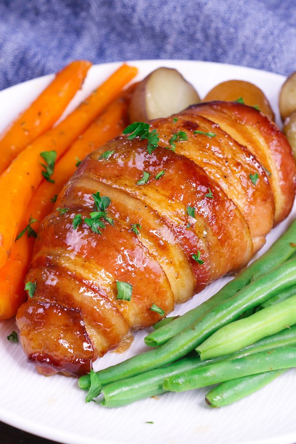 Bacon Brown Sugar Garlic Chicken - this photo shows a closeup of this chicken and bacon recipe on a serving plate with carrots, potatoes and green beans for a beautiful dinner idea