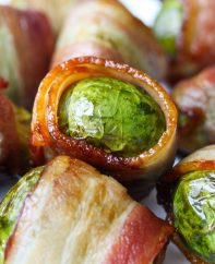 Closeup of bacon wrapped Brussel Sprouts on a serving platter