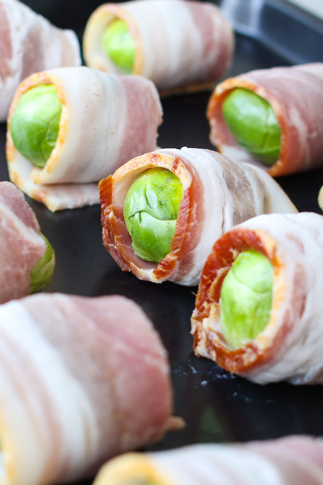 Brussel Sprouts wrapped in bacon on a baking sheet ready for baking