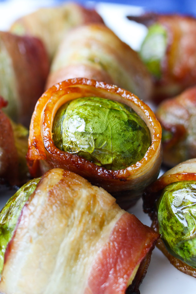 Closeup of bacon wrapped Brussel Sprouts on a serving platter