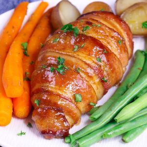 This Brown Sugar Bacon Wrapped Chicken is a simple recipe that everyone will love. Chicken is rubbed with brown sugar and seasonings, wrapped in bacon and baked to golden crispy perfection!