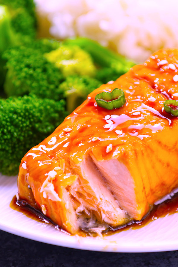 Closeup of salmon flaking after being baked to perfection with a honey garlic sauce. 