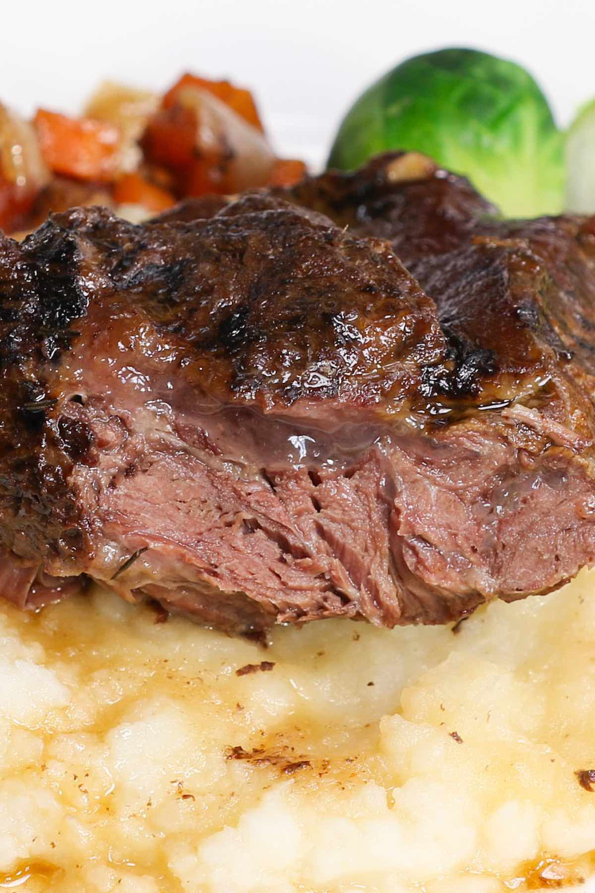 Cross-sectional view of of beef cheek meat after slow cooking showing the marbling and tenderness