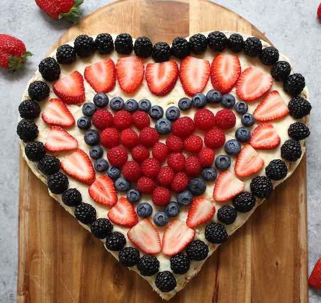 A Heart-shaped cake with fresh berries for a special occasion like Valentine's Day and Mothers Day