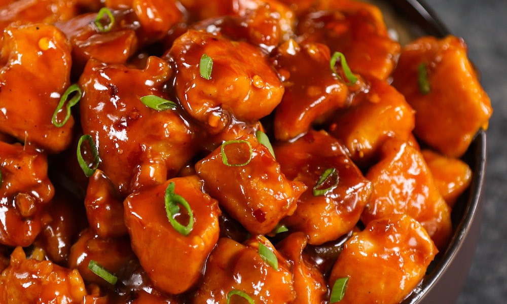 Bourbon Chicken has tender chunks of chicken coated in a sweet and sticky s...