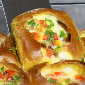 Lifting homemade Breakfast Sliders out of the baking pan