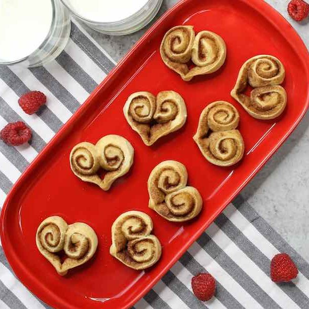 Heart Shaped Cinnamon Rolls on a holiday-themed serving platter