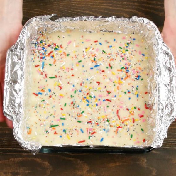 This photo shows cake batter fudge in a pan ready to be chilled