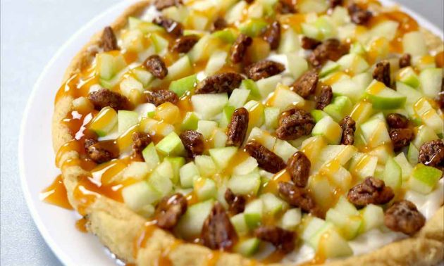 Closeup of Caramel Apple Pizza showing the diced apples, candied pecans and caramel sauce