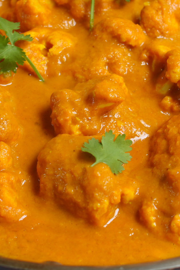 If you love Indian food you have to try this curry recipe. It’s gluten-free and vegan if served on it’s own. But you can also turn this Indian cauliflower curry into an amazing comfort food when you finish it off with white rice or naan bread. A Versatile Vegetable A cup of cauliflower packs just 20 calories and it’s high in vitamin c, calcium, and iron. I am a big fan of this vegetable and often make cauliflower rice for a low-carb alternative. It’s like a blank canvas for whatever flavorings you are in the mood for.  I’ve paired this curried cauliflower with some big flavor such as garlic, ginger, onions, cumin, cinnamon and other spices. You feel free to add your favorite seasonings as you’d like! You can also roast your cauliflower first for additional sweetness and flavor.