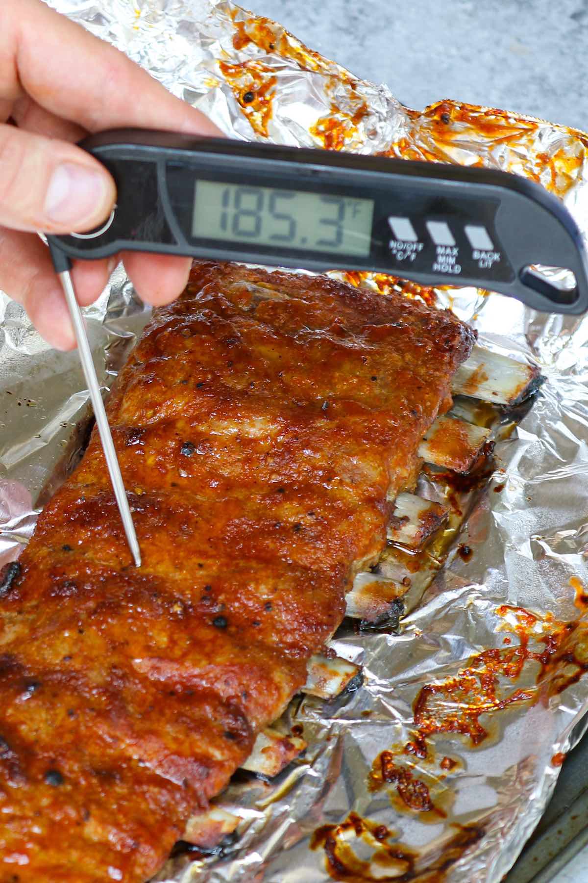 Checking doneness of ribs using an instant read thermometer