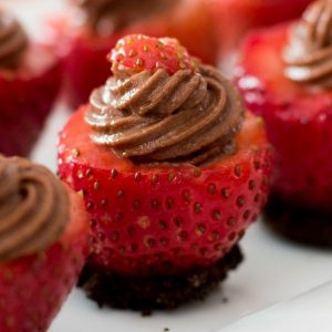 Chocolate Cheesecake Stuffed Strawberries consist of smooth and creamy chocolate cheesecake stuffed in fresh strawberries, all in one bite! A simple and delicious, quick and easy recipe that make a great finger food dessert for parties, brunch, or as an afternoon snack! Great for Mother’s Day! Party food, party dessert recipes. Video recipe. | Tipbuzz.com