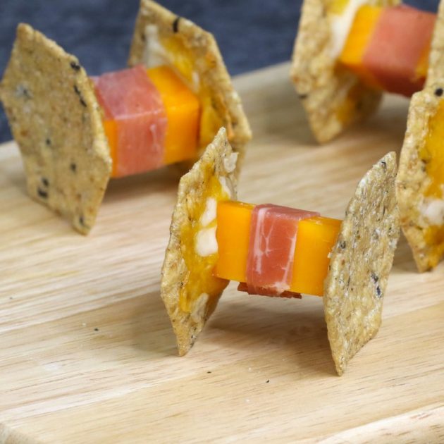 Delicious spaceship crackers as party appetizers made with cheddar cheese, prosciutto and Crunchmaster crackers