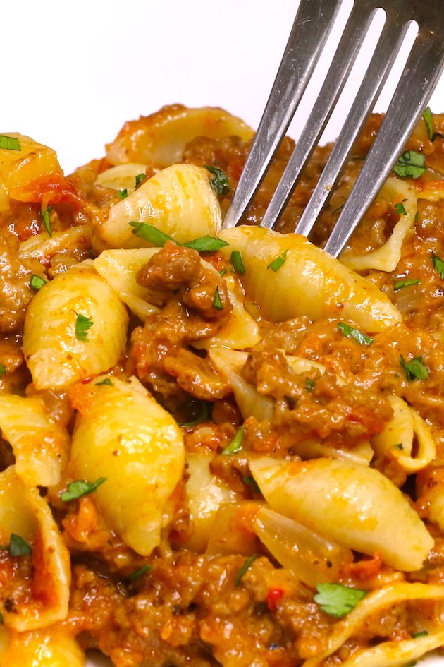 Cheesy taco pasta served on a white plate