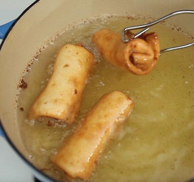 Deep frying chimichangas in a medium saucepan