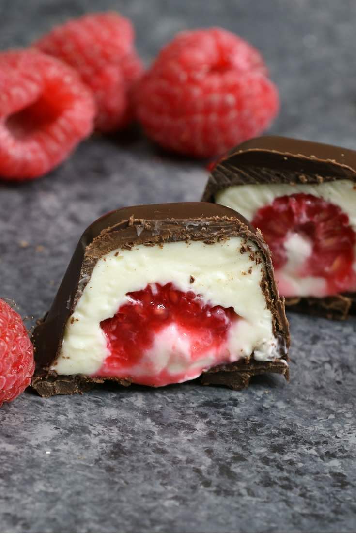 Raspberries Stuffed in smooth and creamy mini cheesecake bites, and then covered by chocolate. The ice cube tray makes it so easy and fun to make! All you need is a few simple ingredients: raspberries, chocolate, cream cheese, sugar, vanilla and whipped cream. An easy recipe that makes a great finger food dessert for parties, brunch, Mother’s Day or as an afternoon snack! Party food, no bake, party dessert recipes. Video recipe. | Tipbuzz.com