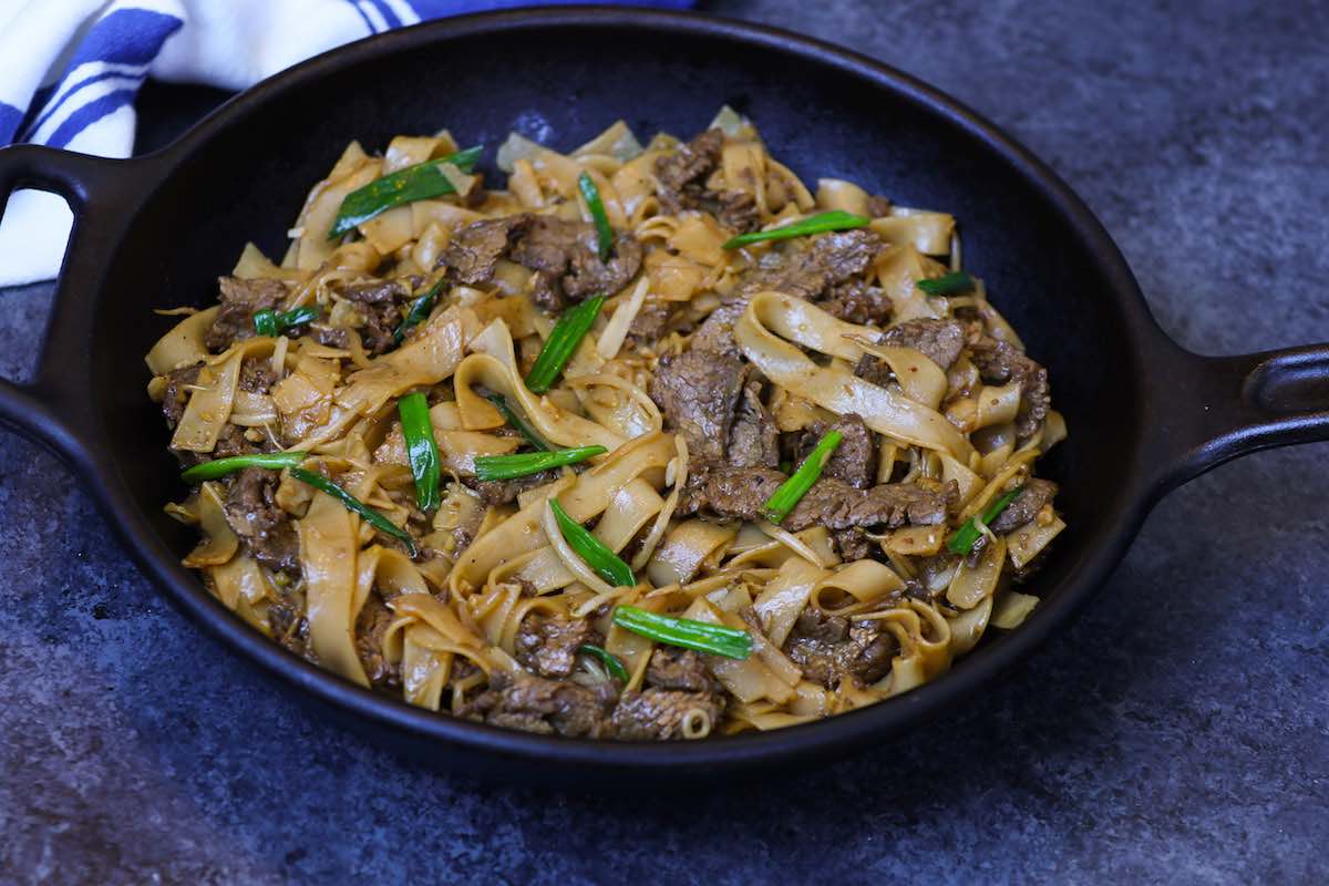Freshly made beef chow fun in a wok