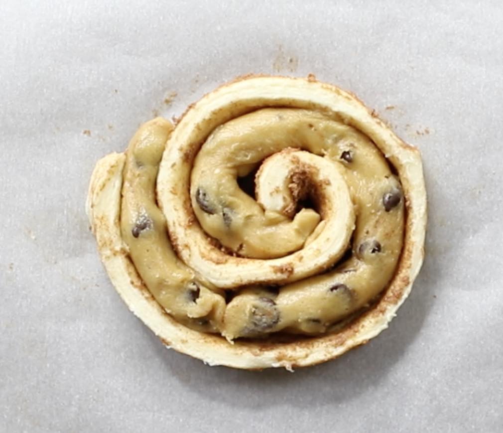 Fitting cookie dough into a cinnamon roll spiral when making cinnamon roll cookies