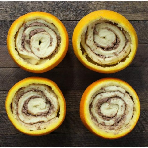 Cinnamon rolls in orange shells before baking