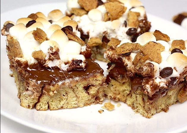 Closeup of Cinnamon Roll Smores on a serving plate showing melted chocolate, marshmallows, graham cracker crumbs and cinnamon rolls