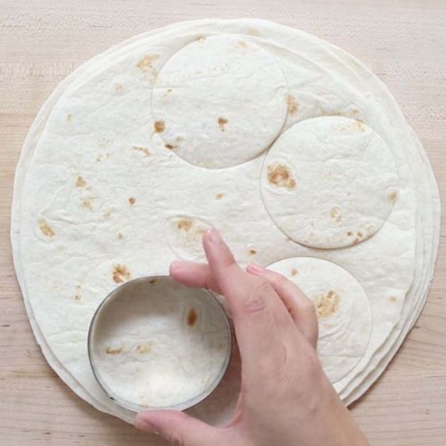 Cutting circles out of tortillas using a round cookie cutter