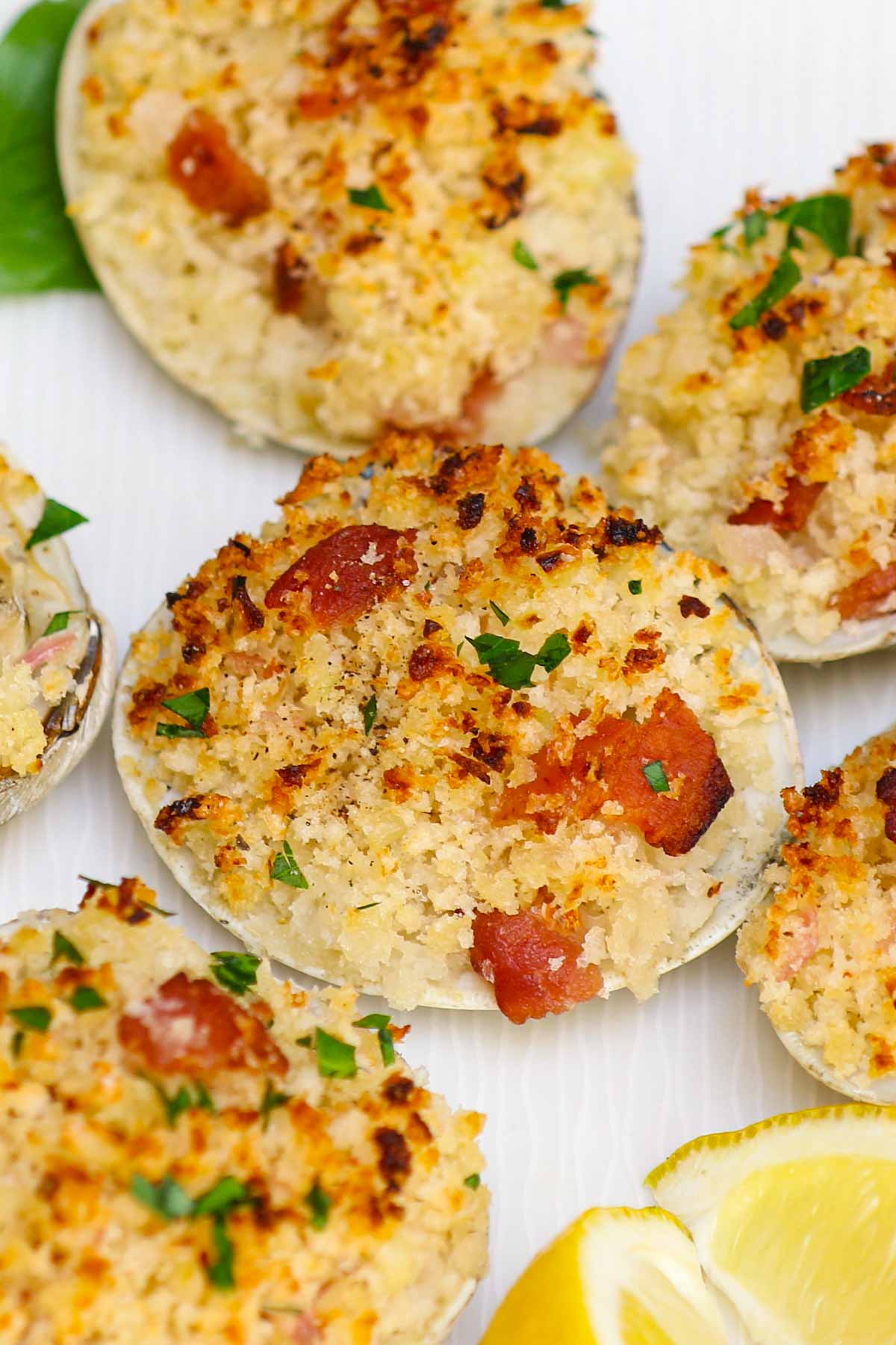 Closeup of clams casino with golden breadcrumbs and crumbed bacon
