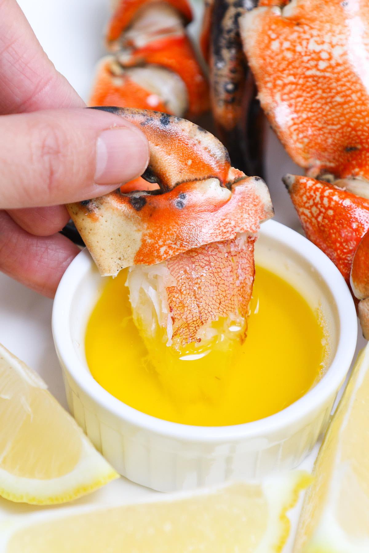 Dipping delicious crab meat into clarified butter with a sprinkle of fresh lemon juice