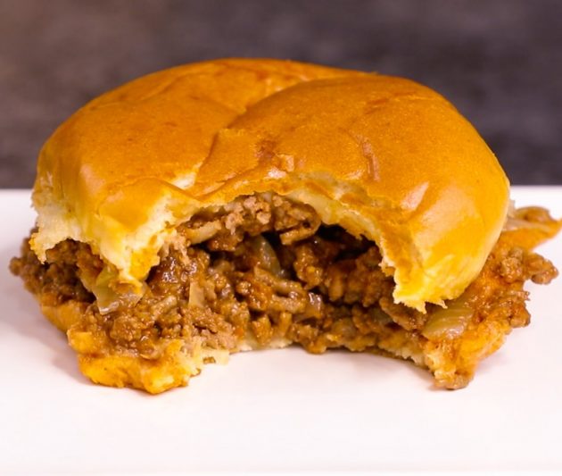 A meaty sloppy joe after taking a bite out of it