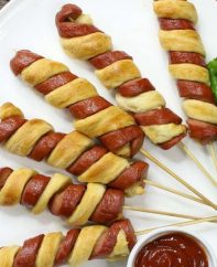 Crescent Roll Hot Dogs with a twist – a super easy and kid friendly snack that comes together in minutes and is a guaranteed hit. All you need is 3 simple ingredients: hot dogs, crescent roll dough and egg wash. It’s great for parties and is so yummy! Video recipe.