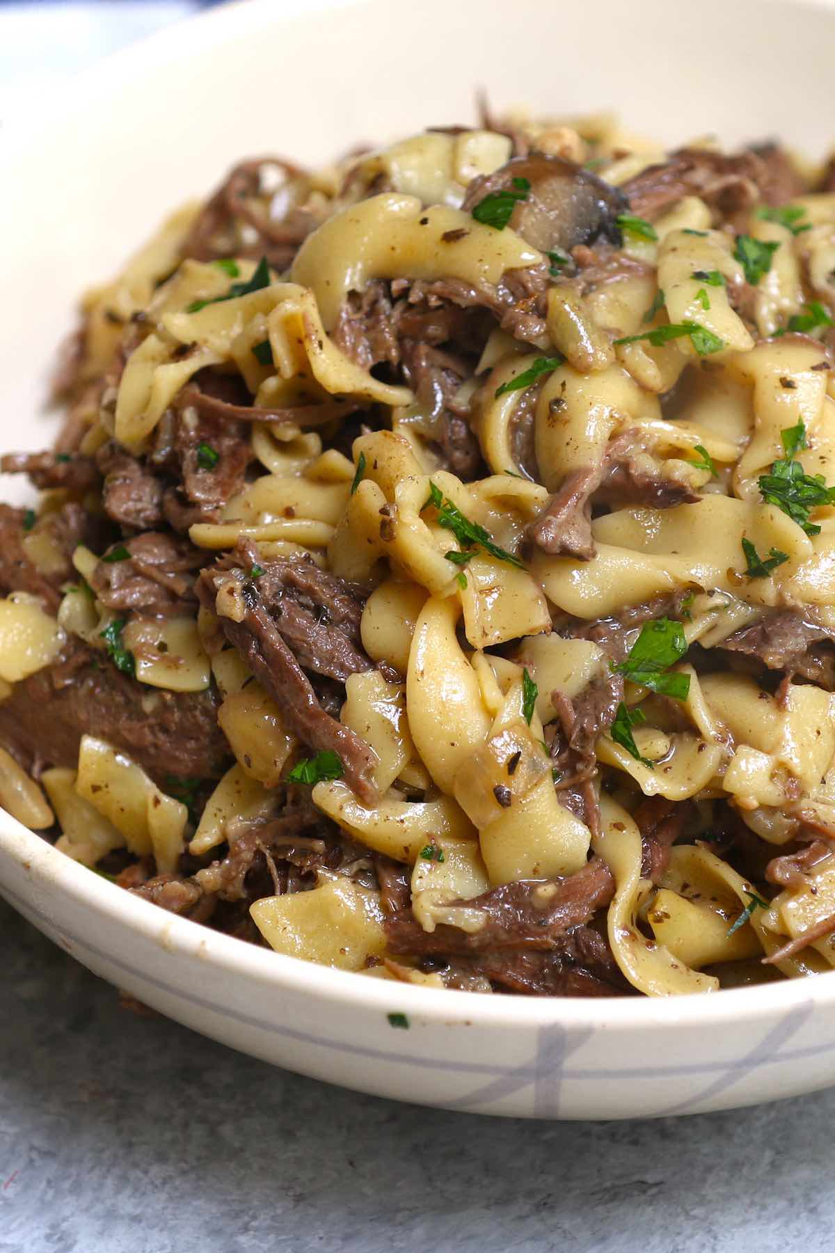 A large serving of beef and noodles in a bowl