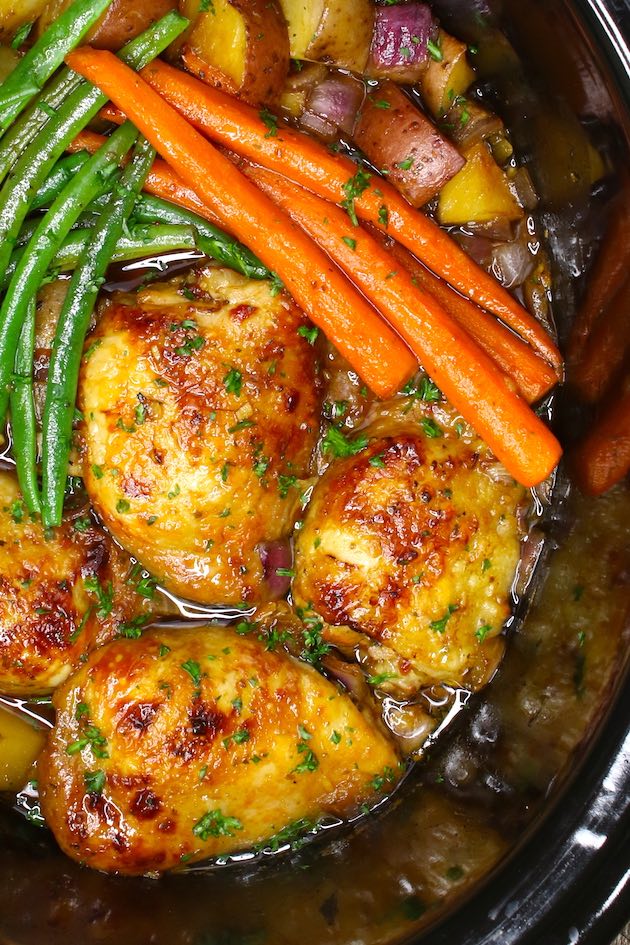 Chicken thighs and veggies are cooked in a 6-quart slow cooker