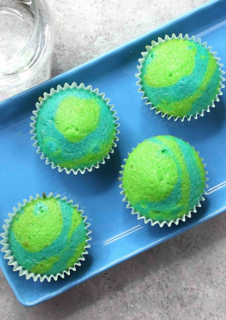 Earth Day cupcakes on a serving platter showing off their beautiful blue and green swirl pattern