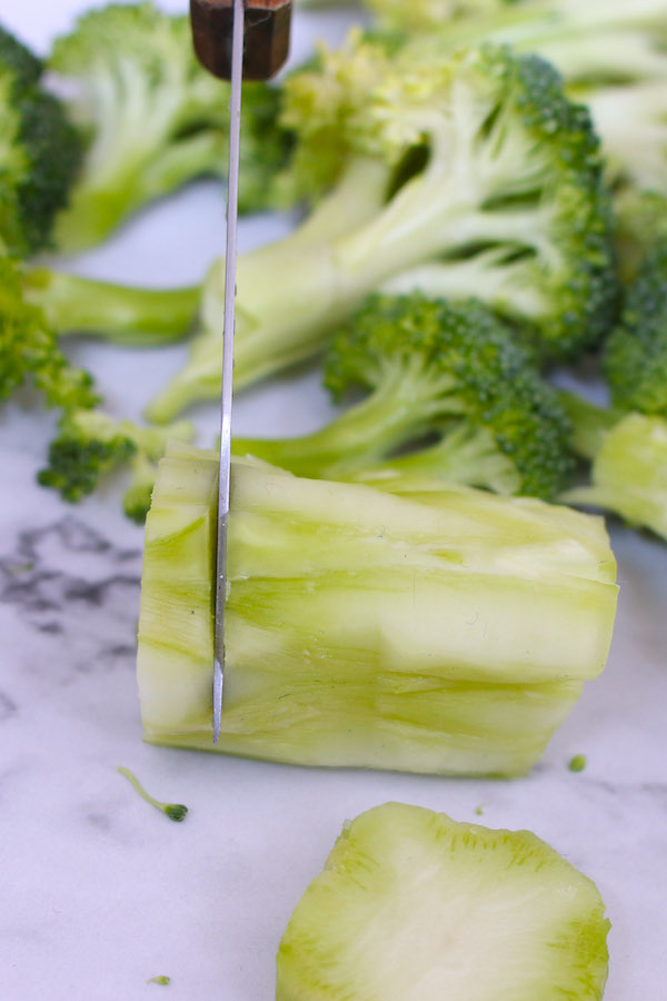 Cut peeled broccoli stem into thin slices