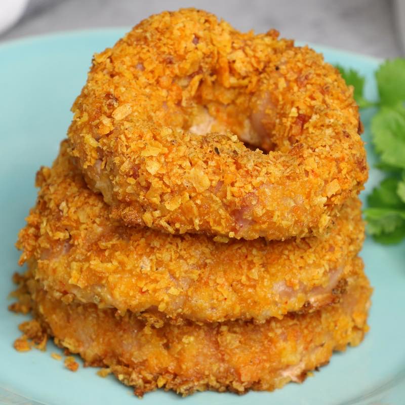 A stack of bacon onion rings with a crispy Doritos crust