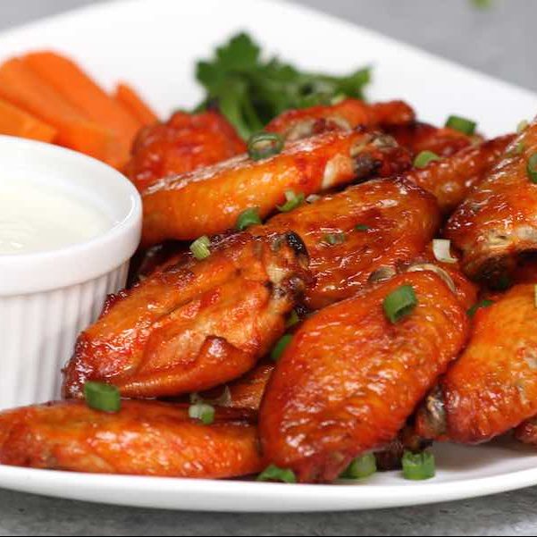 Easy Game Day Chicken Wings on a serving plate with carrot sticks and dipping sauce