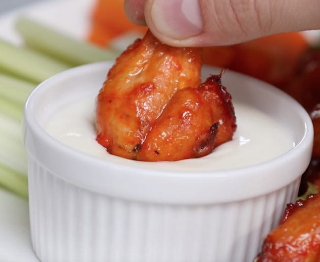 Dipping chicken wings in homemade ranch dressing