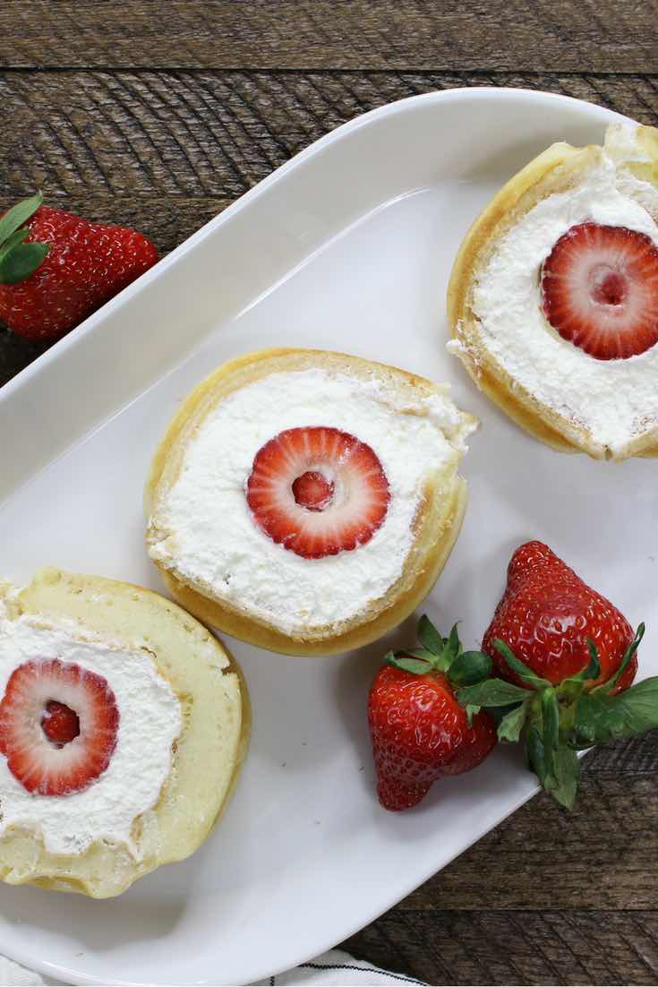 Strawberry Waffle Cake Roll - a quick and easy breakfast, snack or dessert made with waffle mix or frozen waffle, fresh strawberries, and whipped cream. Soft waffle topped with whipped cream, and strawberries. It melts in your mouth! So good and so beautiful! No bake dessert, vegetarian! | tipbuzz.com