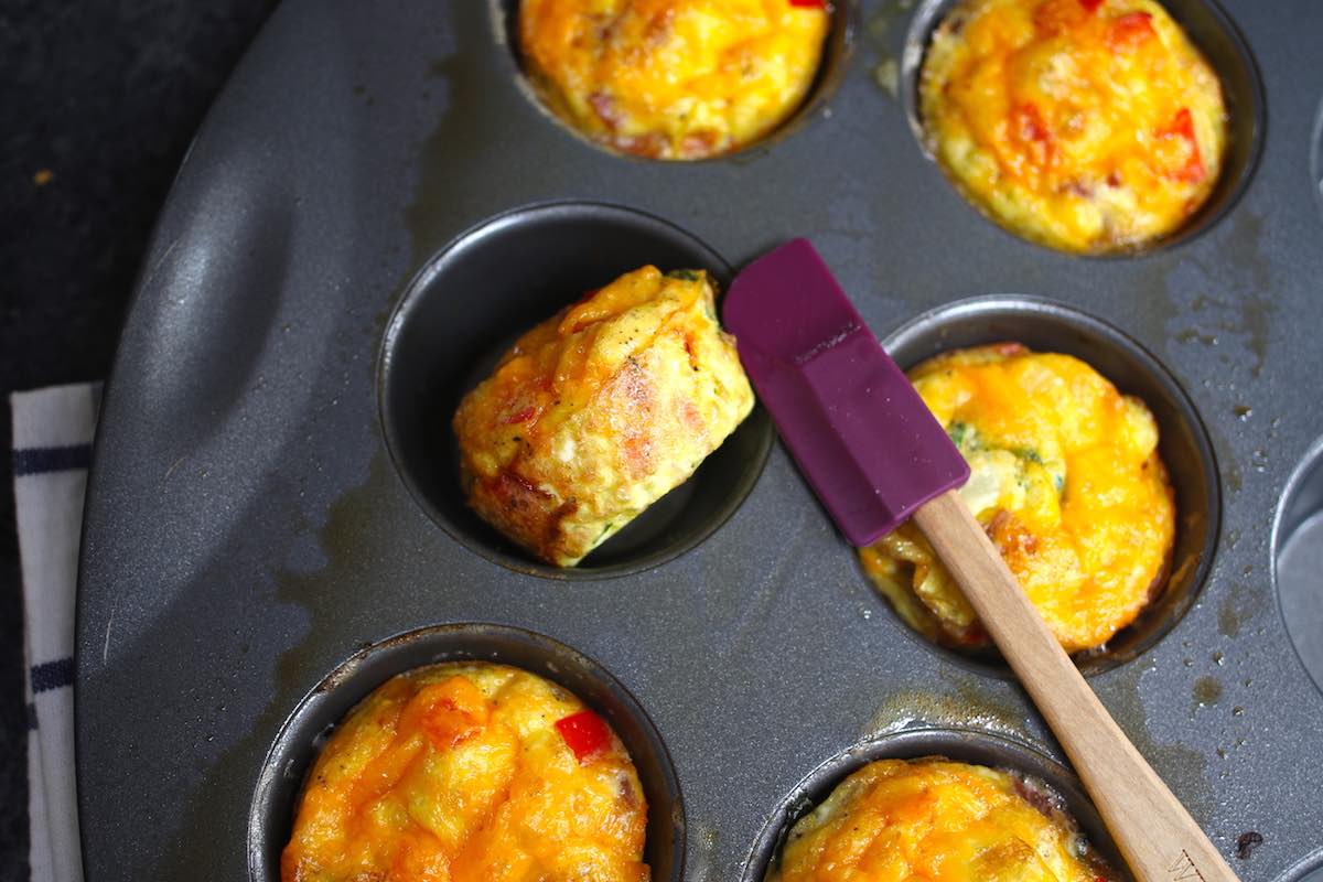 Showing the baked egg muffins not sticking to the muffin pan.