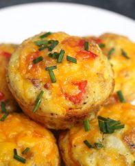 These freezer-friendly Egg Muffins are made with eggs, cheese, bacon, spinach, onions, and bell peppers. An easy make-ahead recipe, they only take a few minutes to throw together. These breakfast muffins are delicious, healthy and nutritious, perfect for busy mornings!
