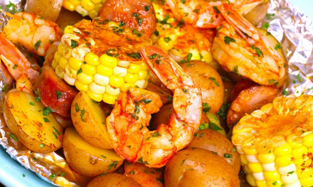 Shrimp Boil in Foil Packets - a delicious shrimp boil recipe you can make at home in foil packets with corn, potatoes and sausage. So delicious. Video recipe